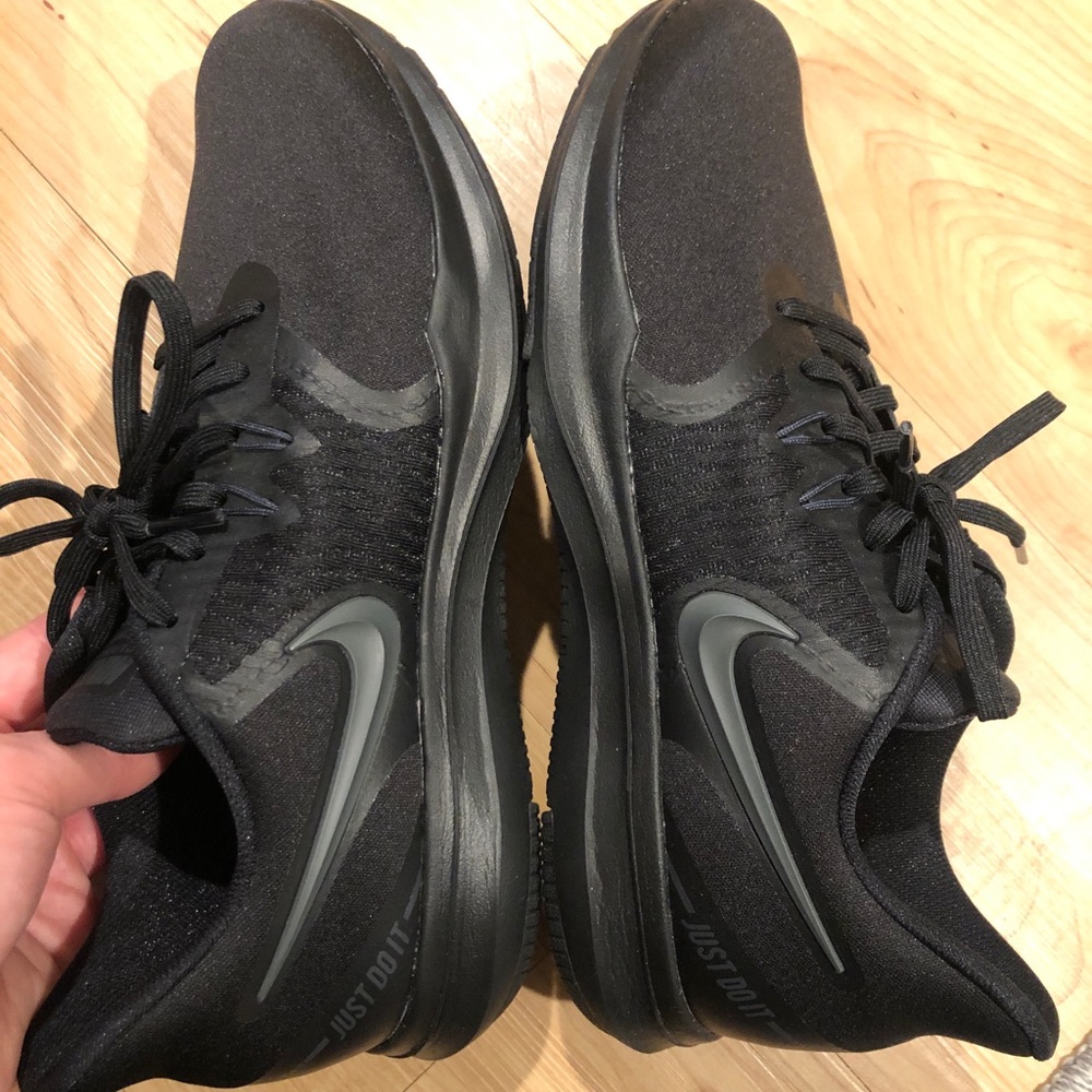 All black Nike tennis shoes